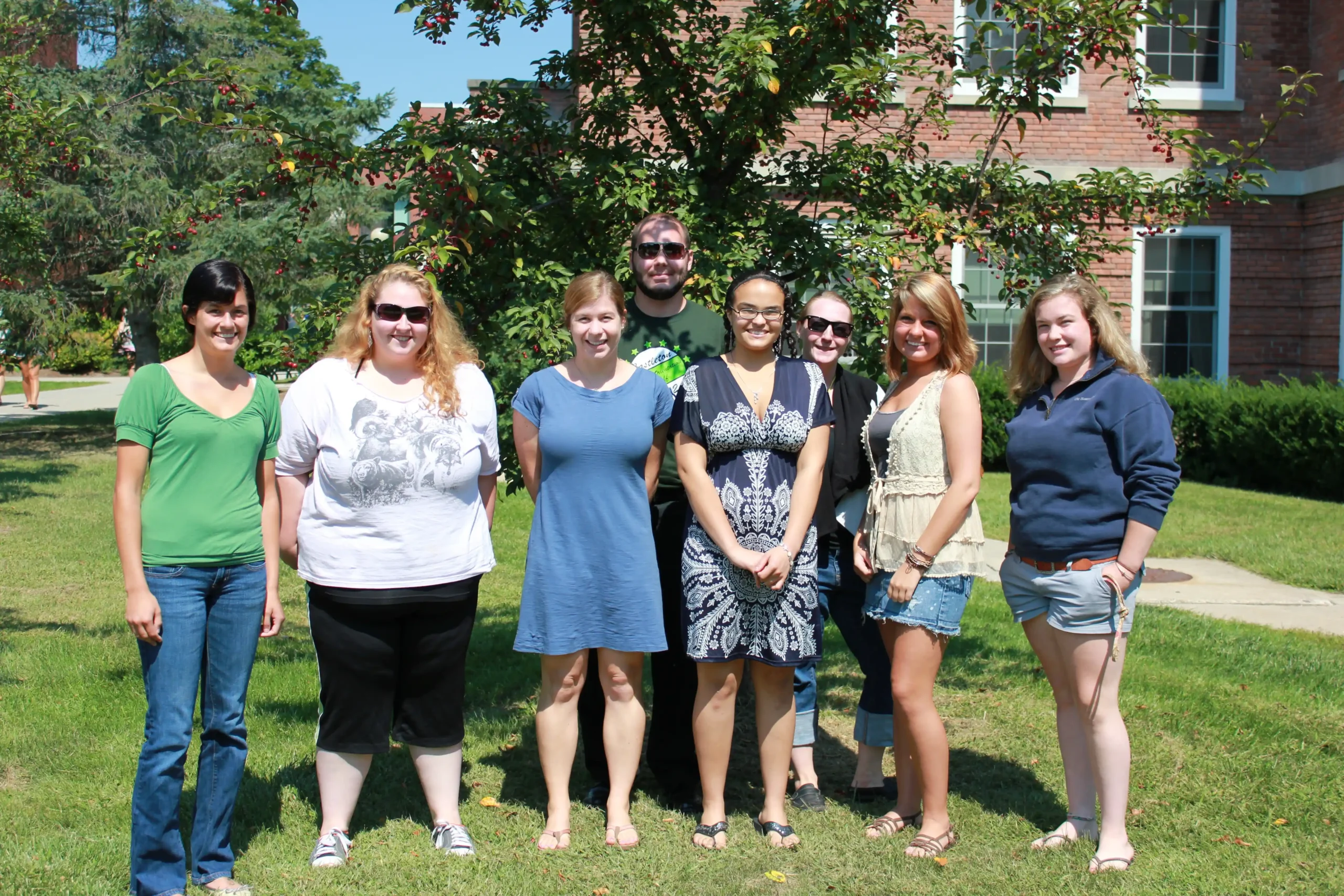 Diverse group of College Steps students and peer mentors standing together on campus grounds for Professionals.