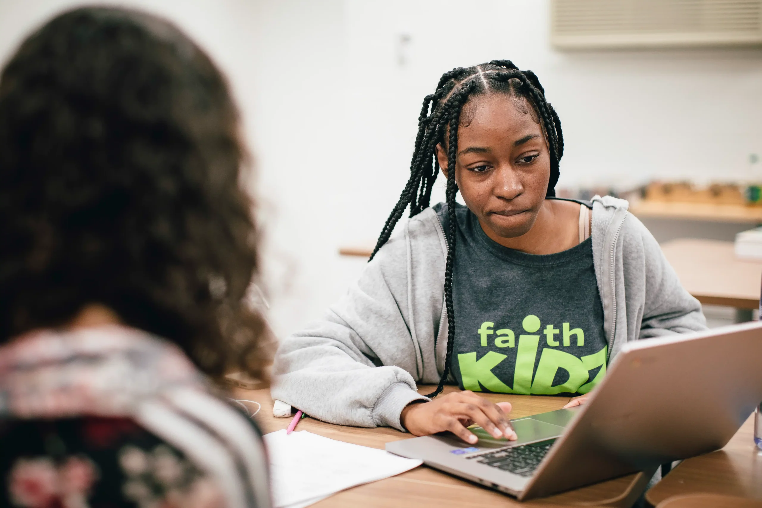 Student working on a laptop during an academic support meeting with Professionals.