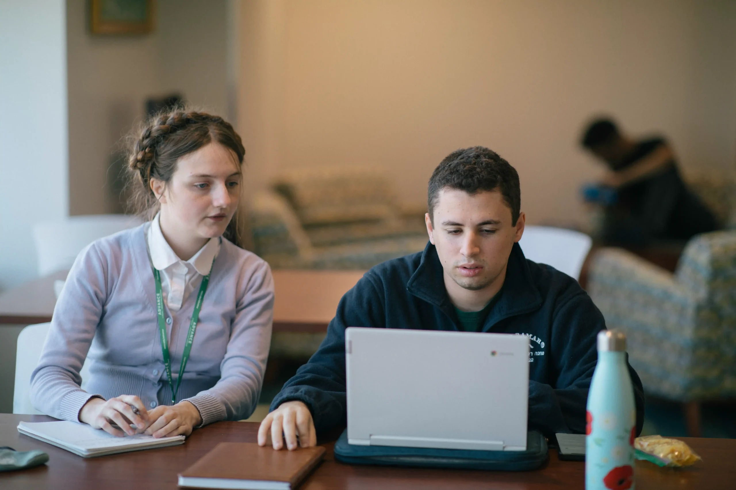 One-on-one study session between a college student and support specialist for Professionals.